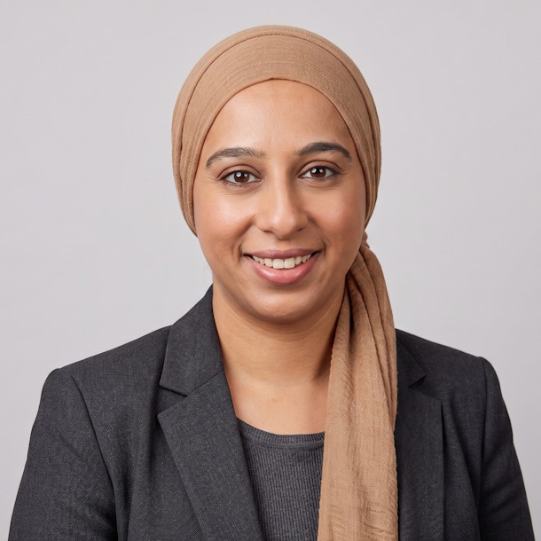 A professional headshot of Asma Sabat, Internal Sales Coordinator, with a neutral studio background, wearing a professional brown hijab and a dark grey blazer.